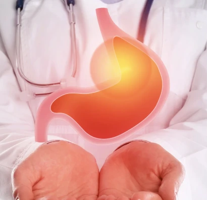 Doctor holding illustration of stomach with acid highlighting hypersensitive GERD