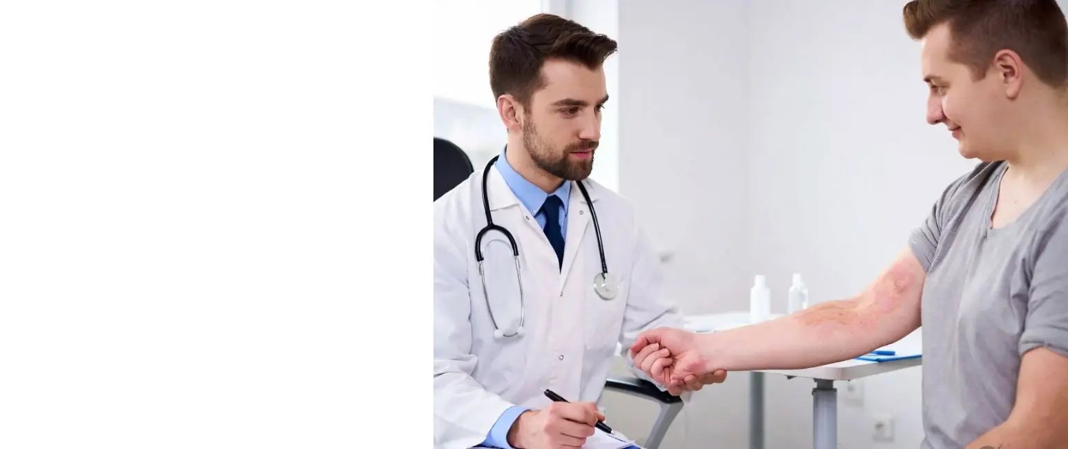 Doctor examining eczema on patient’s arm during consultation