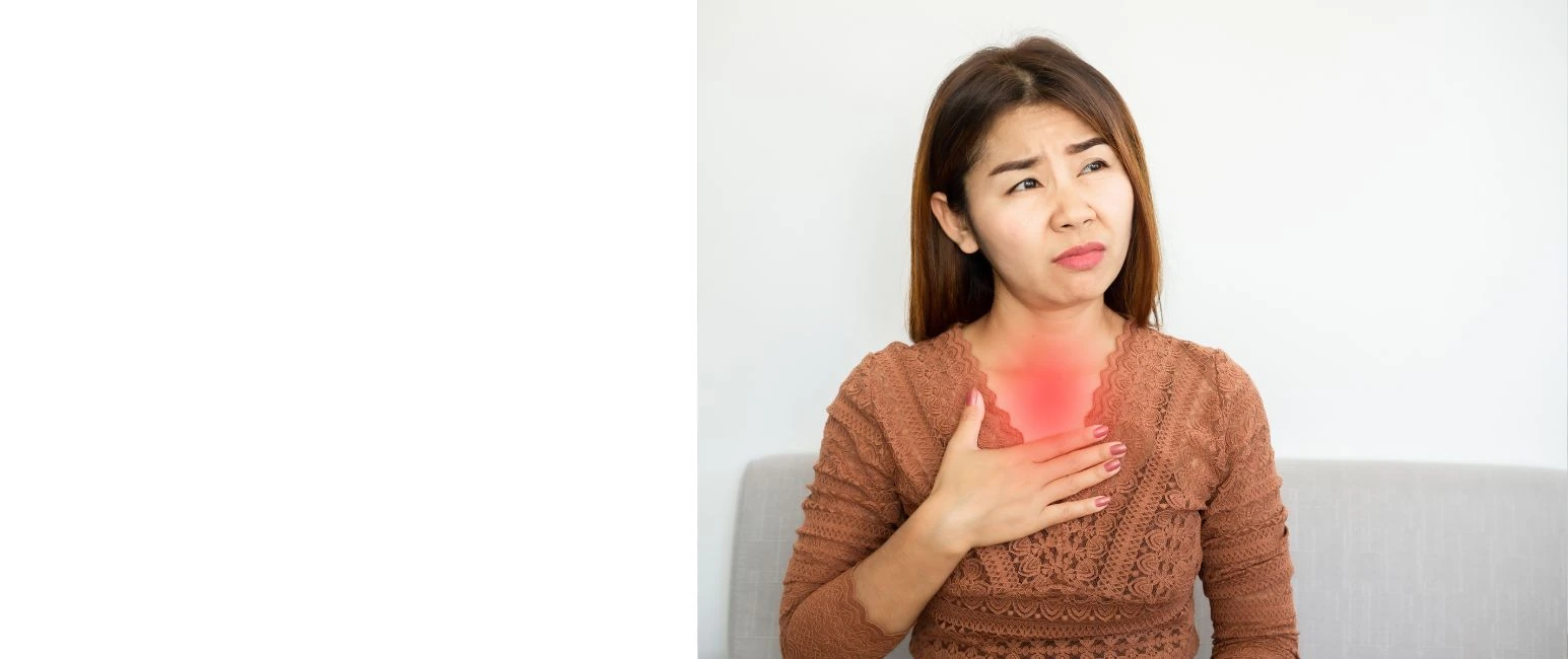Woman experiencing chest discomfort and heartburn due to acid reflux ( GERD )